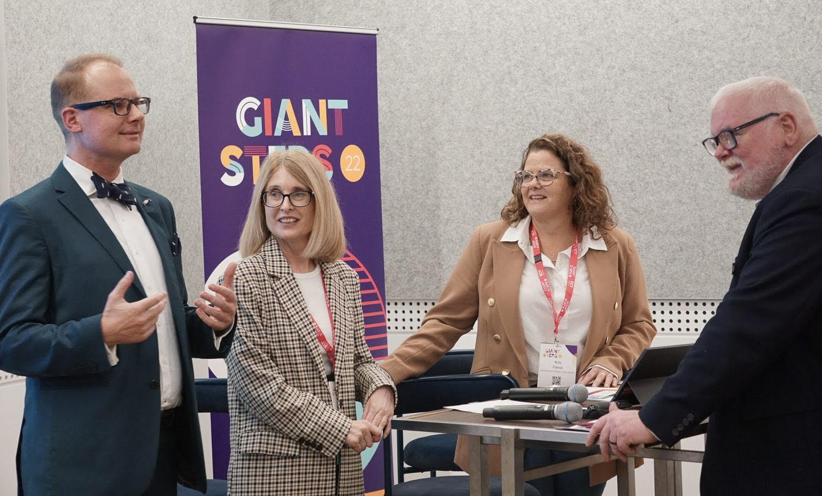 Four workshop attendees discuss co-design ideas