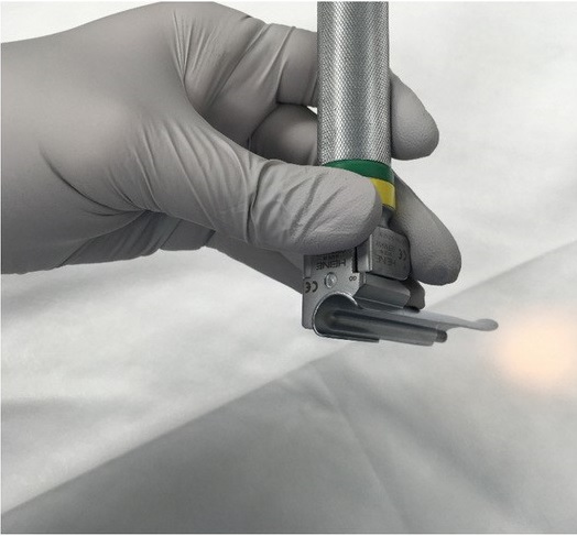 Image showing a gloved hand holding a laryngoscope