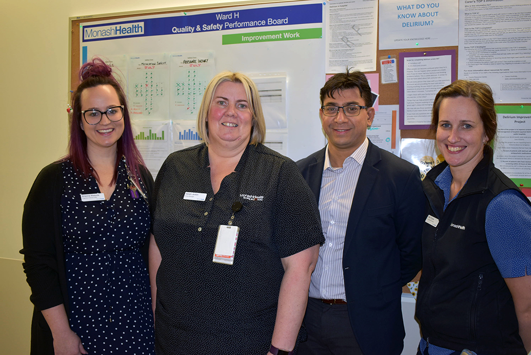 Four staff stand in a hospital setting