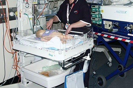 Infant being cooled with gel packs